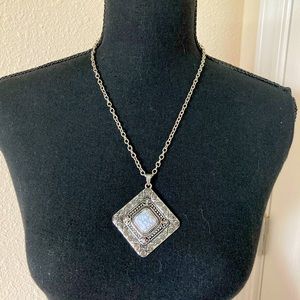 Pendant Necklace. White stone in center.